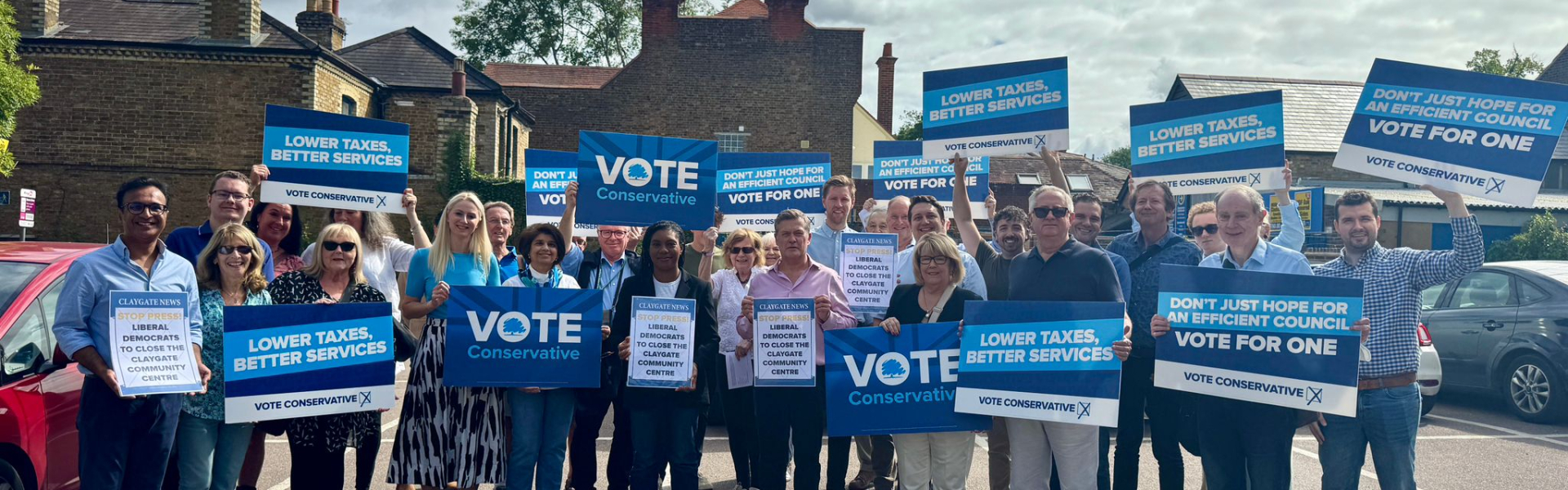 Group holding placards for Conservative campaign.