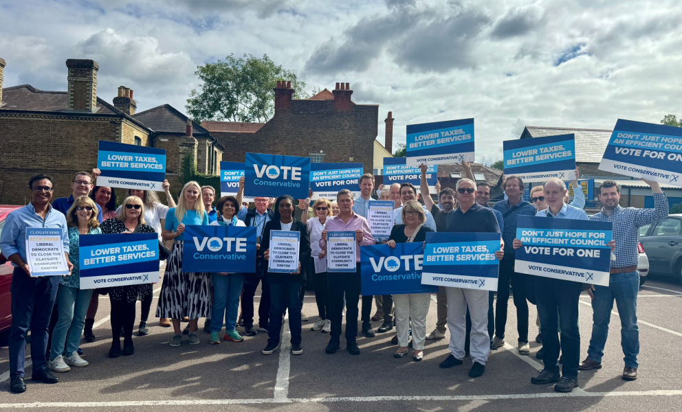 Group holding placards for Conservative campaign.