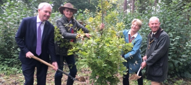 Tim Oliver (left) plants one of Surrey's 1.2 million new trees