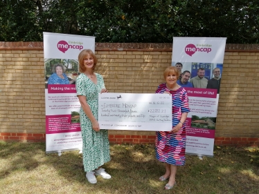 Mary Sheldon presents a cheque to Paula Walsh of Elmbridge Mencap